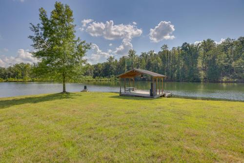 a gazebo on the side of a lake at Fish, Swim and More Lakefront Alabaster Home in Alabaster