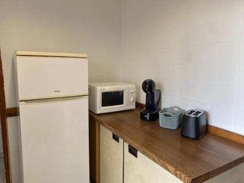 a kitchen with a refrigerator and a microwave on a counter at Piso de alquiler temporal en Fuenlabrada in Fuenlabrada