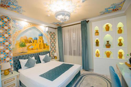 a bedroom with a bed and a chandelier at Gur Emir Palace boutique hotel in Samarkand