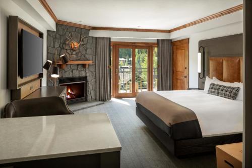 a hotel room with a bed and a fireplace at The Hythe, a Luxury Collection Resort, Vail in Vail