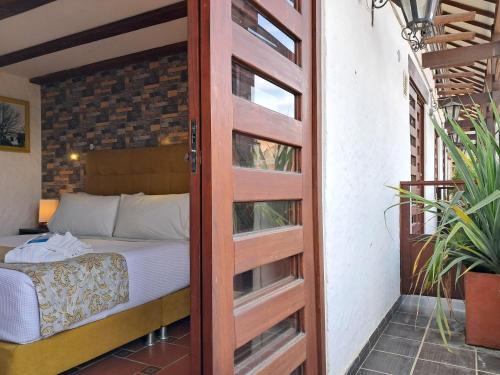 a door leading into a bedroom with a bed at La Floresta de Cite Hotel in Cite