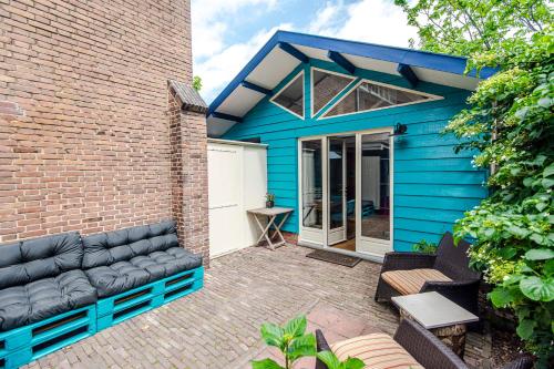a blue house with a couch in front of it at Ocho in Zandvoort
