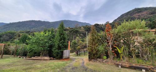 a dirt road in a field with mountains in the background at Refúgio Mantiqueira - Parte Alta Parque Nacional Itatiaia in Itamonte