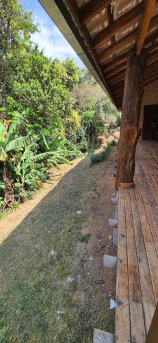 a porch of a house with a wooden roof at Refúgio Mantiqueira - Parte Alta Parque Nacional Itatiaia in Itamonte