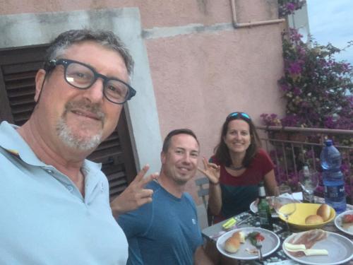 a group of people sitting at a table with food at Bed & Breakfast StudioArcodia- in San Marco dʼAlunzio