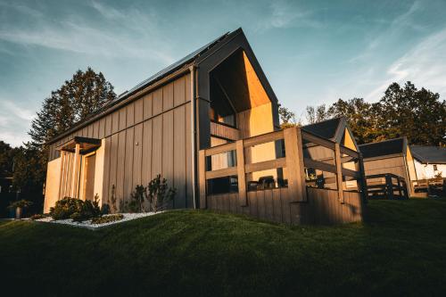 a house with a large window on the side of it at Bobrowe Wzgórza Resort in Jelenia Góra