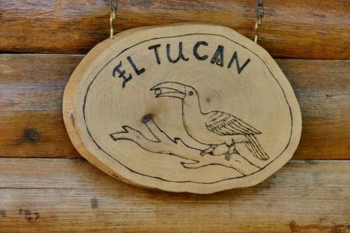 a wooden sign with a bird on a wooden wall at Ecolodge La Corocora in Monterrey