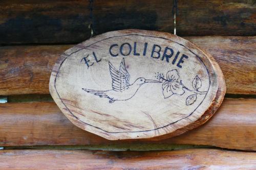 a wooden sign that says coll bird on a wall at Ecolodge La Corocora in Monterrey