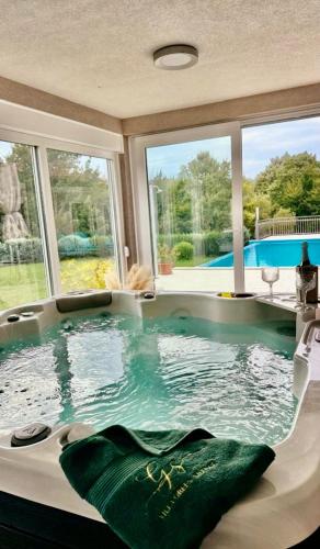 a large bath tub with green towels in it at Villa Heaven Green in Pazin