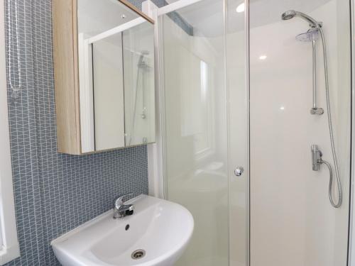 a bathroom with a sink and a shower at Hazel in Denny