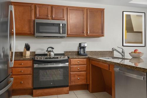 a kitchen with a stove and a microwave at The Westin Desert Willow Villas, Palm Desert in Palm Desert