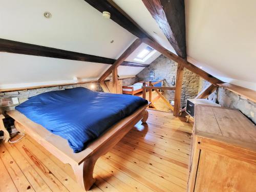 a bedroom with a bed in a attic at Gites Rausa in Modave