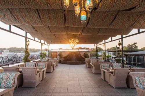 a covered patio with chairs and a fountain at Gur Emir Palace boutique hotel in Samarkand