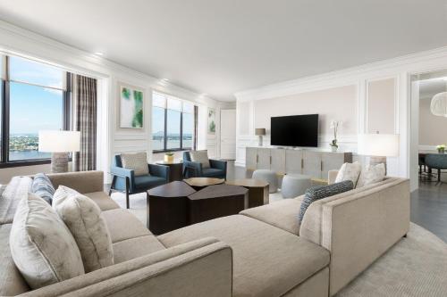 a living room with a couch and a tv at The Westin New Orleans in New Orleans