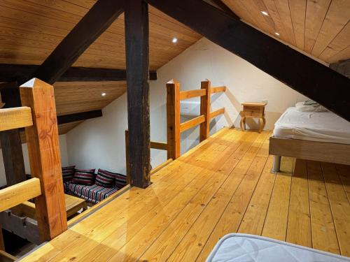 a attic room with two bunk beds and a bed at Gites Rausa in Modave
