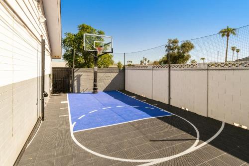 a basketball hoop on a court in a house at Heated pool, Sports Court, Pool table, King beds in Tempe Junction