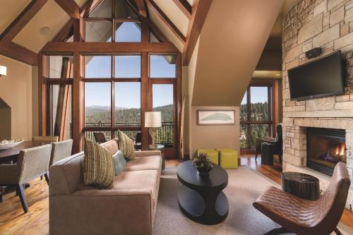 a living room with a couch and a fireplace at The Ritz-Carlton, Lake Tahoe in Truckee