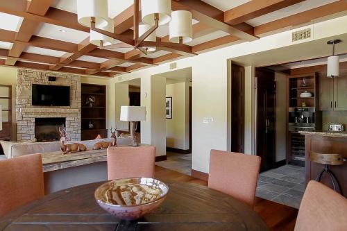 a living room with a table and chairs and a fireplace at The Ritz-Carlton, Lake Tahoe in Truckee