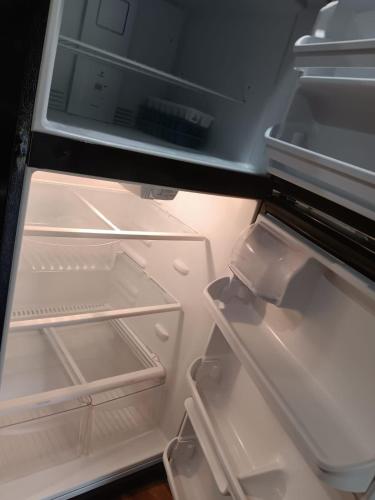 an open refrigerator with its door open and its doorsktop at Mins to Downtown - Huntsville Oasis in Huntsville