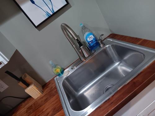 a kitchen sink with a faucet on top of it at Mins to Downtown - Huntsville Oasis in Huntsville