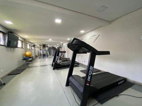 a gym with several tread machines in a room at Flat club perto metrô Santana in Sao Paulo