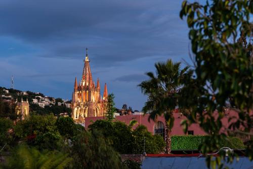 a cathedral with a cross on top of a building at Casa Quebrada, New 3BR Modern Home in Centro in San Miguel de Allende