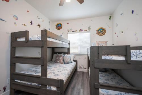 a bedroom with two bunk beds and a window at Game Room! Rooftop Deck! Sleeps 11 in Oceano