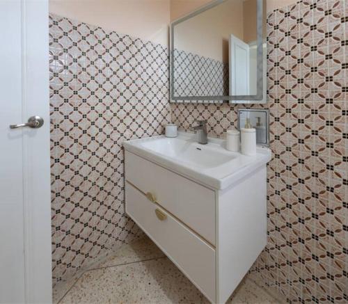 a bathroom with a white sink and a mirror at Hacienda Cumbre Bella in Ciales