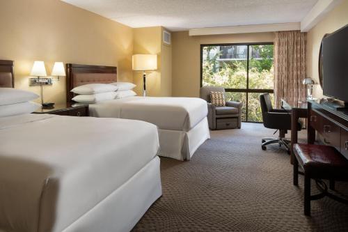 a hotel room with two beds and a window at Sheraton Palo Alto Hotel in Palo Alto