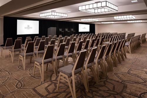 a row of chairs in a room with a screen at Sheraton Palo Alto Hotel in Palo Alto