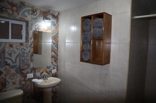 a bathroom with a sink and a toilet at La Casona de los Abuelos in Creel