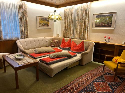 a living room with a couch with pillows on it at ALTSTADT-APARTMENTS Bad Radkersburg - Ihr Zuhause auf Reisen in Bad Radkersburg