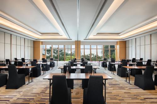 an empty dining room with tables and chairs at The Westin Jakarta in Jakarta