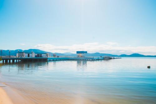a dock in the middle of a body of water at Hotel Villareal São Francisco do Sul in São Francisco do Sul