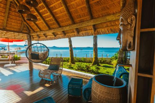 a porch with a view of the ocean at Hotel Villareal São Francisco do Sul in São Francisco do Sul