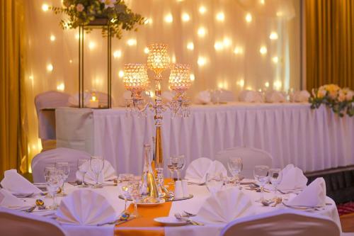 a table set up for a wedding with a chandelier at Sheraton Athlone Hotel in Athlone