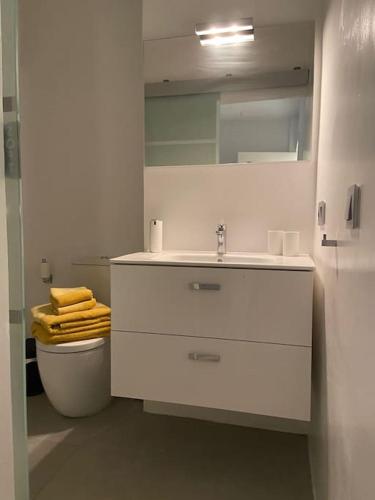 a white bathroom with a sink and a toilet at MAMI Apto 3 in San Sebastián de la Gomera