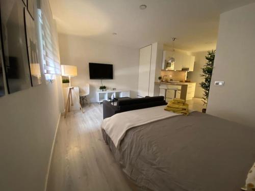 a bedroom with a bed and a living room at MAMI Apto 3 in San Sebastián de la Gomera