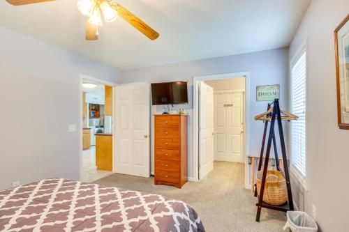 a bedroom with a bed and a dresser and a kitchen at Chapin Home Near Boat Launch and Lake Murray! in Lake Murray Shores