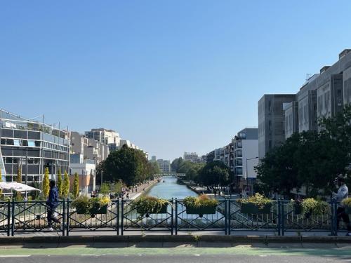 a view of a river in a city with buildings at Studio de charme in Pantin