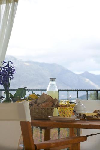 a table with a basket of food and a bottle of milk at Villa Maris in Melissourgákion