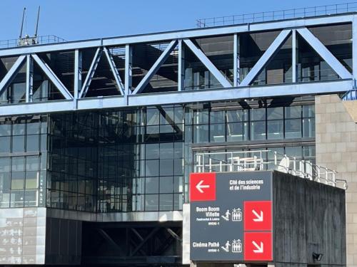 a large glass building with a sign in front of it at Studio number 10 in Pantin