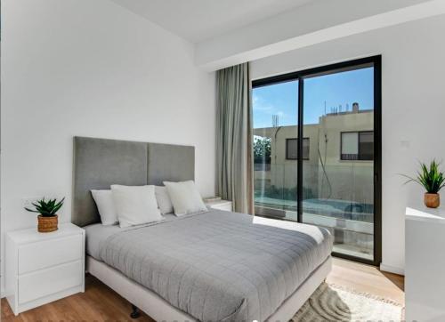 Postel nebo postele na pokoji v ubytování Olive Shared Pool Apartments