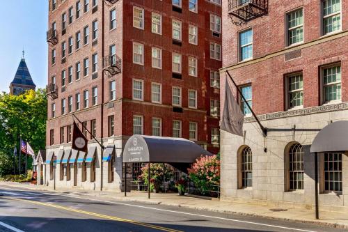 a building on a city street with a black umbrella at Sheraton Commander Hotel in Cambridge