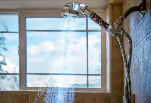 a shower head with water coming out of it at Cozy foothills home in Grass Valley