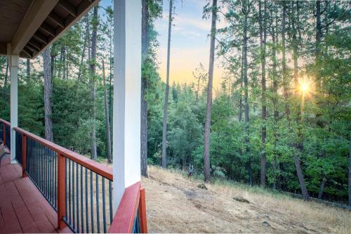 a porch of a house with a view of the forest at Cozy foothills home in Grass Valley