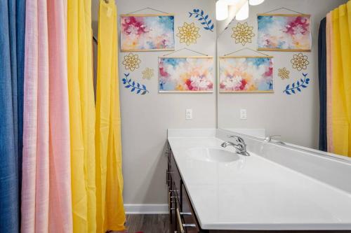 a bathroom with a sink and a mirror at Roomy Getaway! Elevate Your Stay 6 Mins to RIC! in Sandston