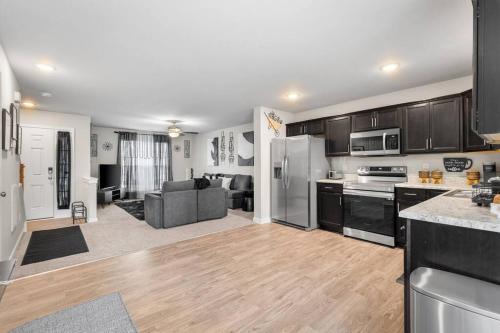 an open kitchen and living room in a apartment at Roomy Getaway! Elevate Your Stay 6 Mins to RIC! in Sandston