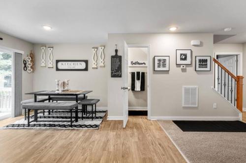 a dining room with a table and a table and a door at Roomy Getaway! Elevate Your Stay 6 Mins to RIC! in Sandston