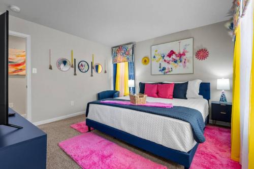 a bedroom with a large bed and a pink rug at Roomy Getaway! Elevate Your Stay 6 Mins to RIC! in Sandston